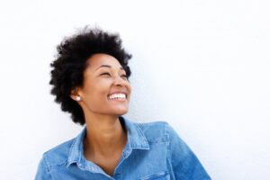 woman smiling in front a white background